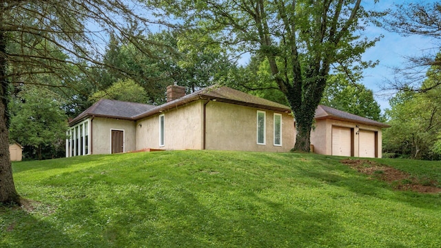 2830 Silver St, Granville, OH 43023 - view of home's exterior featuring a chimney, stucco siding, and a yard