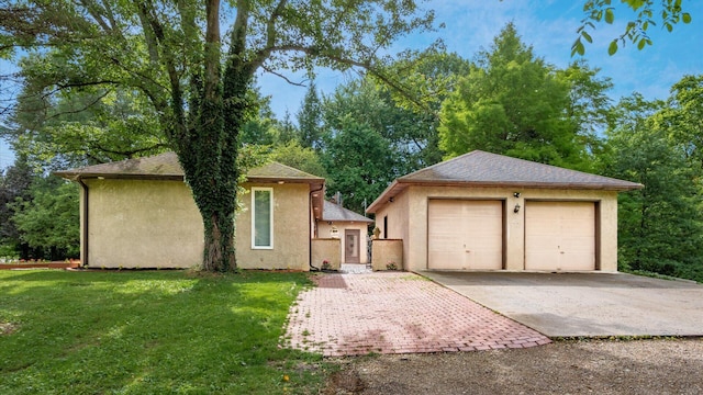 2830 Silver St, Granville, OH 43023 - view of front facade with stucco siding, a garage, an outdoor structure, and a front yard