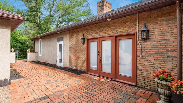2830 Silver St, Granville, OH 43023 - entrance to property featuring brick siding, a patio, a chimney, and french doors