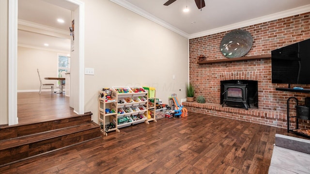 2830 Silver St, Granville, OH 43023 - game room with a wood stove, wood finished floors, ceiling fan, crown molding, and recessed lighting
