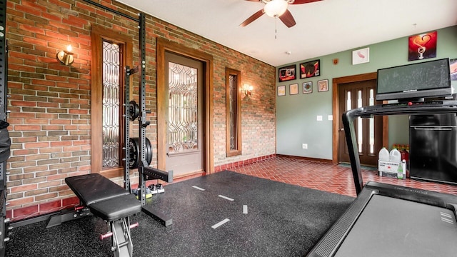 2830 Silver St, Granville, OH 43023 - exercise room featuring ceiling fan, brick wall, and brick patterned floors