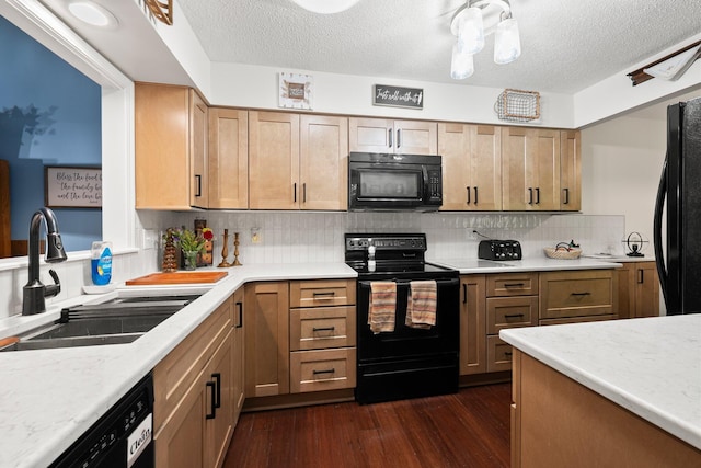 3903 Inverness Cir, Dublin, OH 43016 - kitchen with black appliances, dark wood-style flooring, light countertops, decorative backsplash, and a textured ceiling