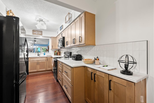 3903 Inverness Cir, Dublin, OH 43016 - kitchen with black appliances, light countertops, dark wood-type flooring, a textured ceiling, and a ceiling fan