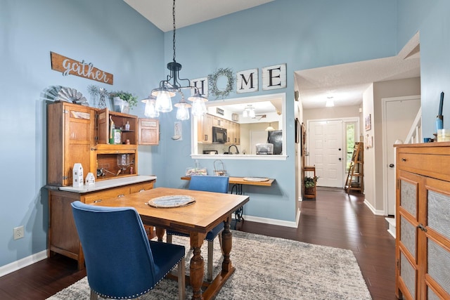 3903 Inverness Cir, Dublin, OH 43016 - dining room with a chandelier, dark wood-style floors, and a towering ceiling