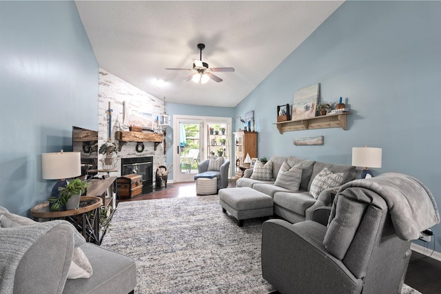 3903 Inverness Cir, Dublin, OH 43016 - living room featuring lofted ceiling, wood finished floors, ceiling fan, and a stone fireplace