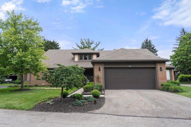 3903 Inverness Cir, Dublin, OH 43016 - view of front of property featuring brick siding, an attached garage, a front lawn, asphalt driveway, and a shingled roof