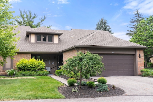 3903 Inverness Cir, Dublin, OH 43016 - view of front facade with brick siding, a garage, a shingled roof, a front yard, and driveway