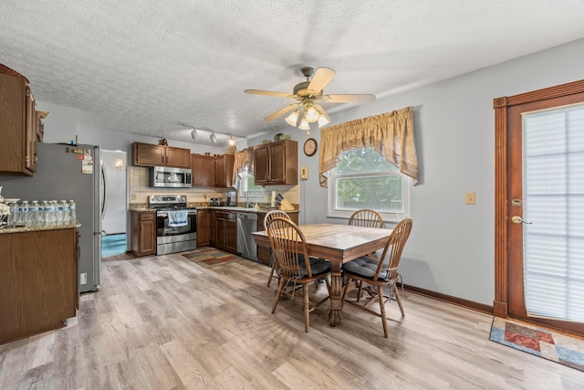 5681 Mcbride Ct, Dublin, OH 43016 - dining space with light wood-style floors, ceiling fan, and a textured ceiling