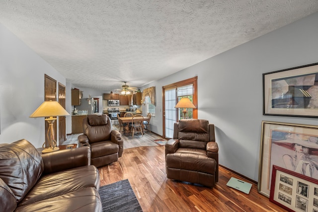 5681 Mcbride Ct, Dublin, OH 43016 - living room featuring ceiling fan, light wood-style flooring, and a textured ceiling