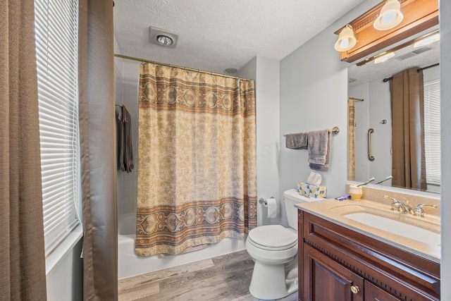 5681 Mcbride Ct, Dublin, OH 43016 - bathroom featuring wood finished floors, vanity, shower / bath combo, and a textured ceiling