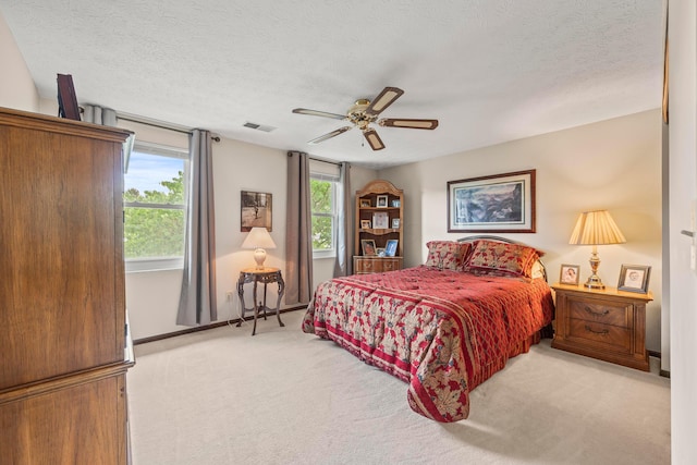 5681 Mcbride Ct, Dublin, OH 43016 - bedroom featuring light colored carpet, multiple windows, a textured ceiling, and ceiling fan