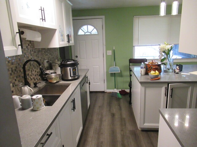 1881 Brimfield Rd, Columbus, OH 43229 - kitchen featuring backsplash, dark wood-type flooring, white cabinetry, and light stone counters