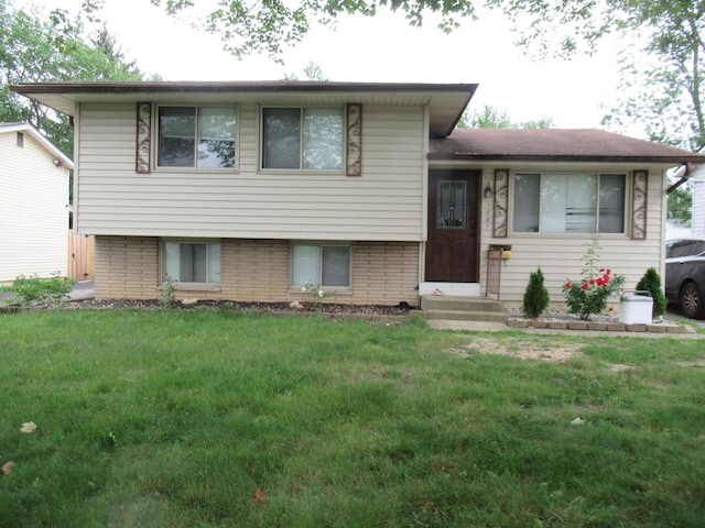 1881 Brimfield Rd, Columbus, OH 43229 - split level home featuring a front lawn, brick siding, and entry steps