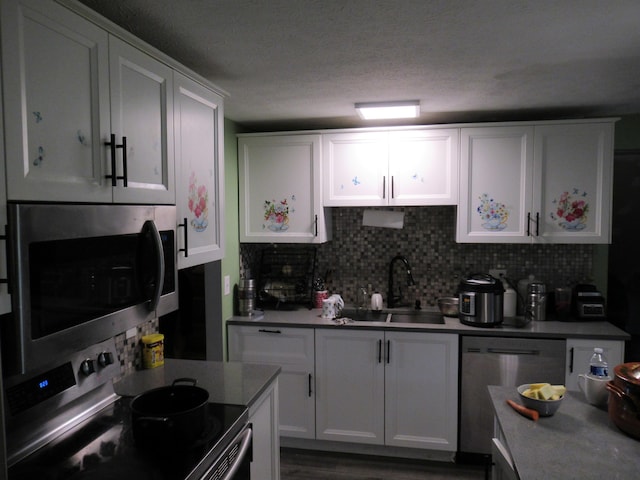 1881 Brimfield Rd, Columbus, OH 43229 - kitchen featuring appliances with stainless steel finishes, white cabinets, and decorative backsplash