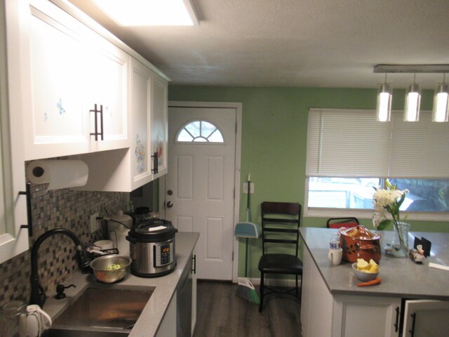 1881 Brimfield Rd, Columbus, OH 43229 - kitchen featuring tasteful backsplash, white cabinets, dark wood-style floors, light countertops, and a textured ceiling