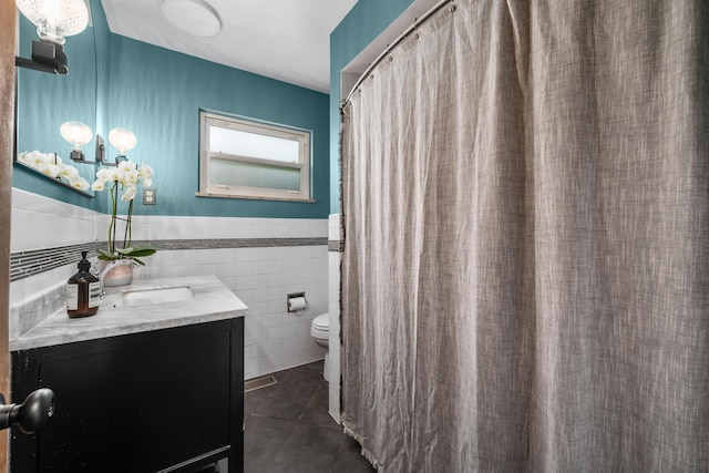 3287 Leighton Rd, Columbus, OH 43221 - full bathroom with vanity, tile patterned floors, tile walls, and wainscoting