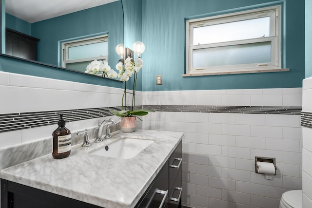 3287 Leighton Rd, Columbus, OH 43221 - bathroom with vanity, tile walls, and a wainscoted wall