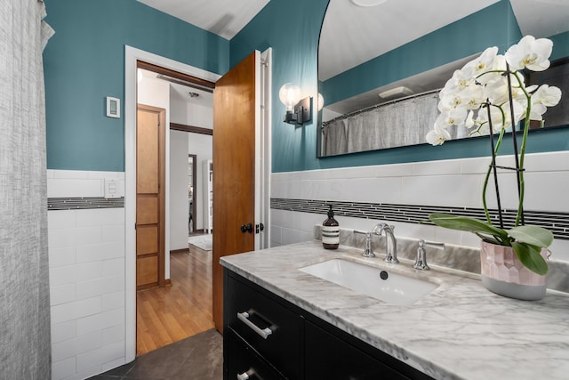 3287 Leighton Rd, Columbus, OH 43221 - bathroom featuring tile walls, vanity, a wainscoted wall, and curtained shower
