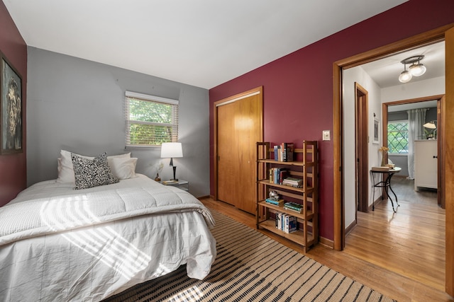 3287 Leighton Rd, Columbus, OH 43221 - bedroom featuring wood finished floors, multiple windows, and a closet