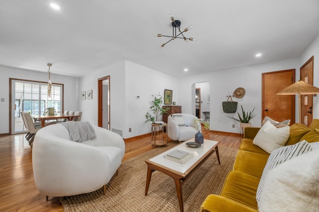 3287 Leighton Rd, Columbus, OH 43221 - living room with a chandelier, arched walkways, light wood-style flooring, and recessed lighting