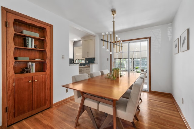 3287 Leighton Rd, Columbus, OH 43221 - dining space with a chandelier and light wood-style flooring