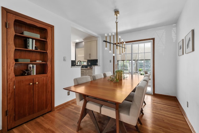 3287 Leighton Rd, Columbus, OH 43221 - dining room featuring a chandelier and wood finished floors