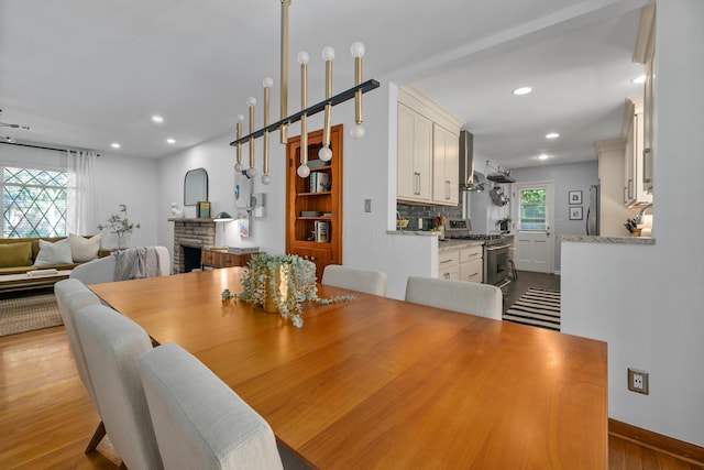 3287 Leighton Rd, Columbus, OH 43221 - dining area with wood finished floors, a fireplace, and recessed lighting