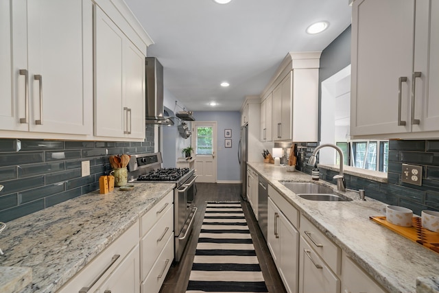 3287 Leighton Rd, Columbus, OH 43221 - kitchen with range with two ovens, wall chimney range hood, decorative backsplash, white cabinets, and recessed lighting