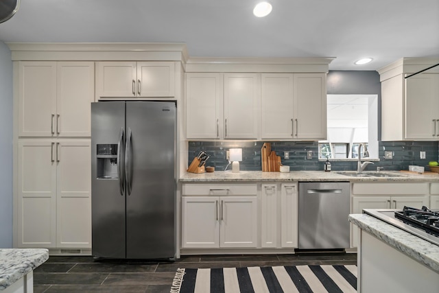 3287 Leighton Rd, Columbus, OH 43221 - kitchen featuring appliances with stainless steel finishes, backsplash, recessed lighting, light stone countertops, and dark wood finished floors