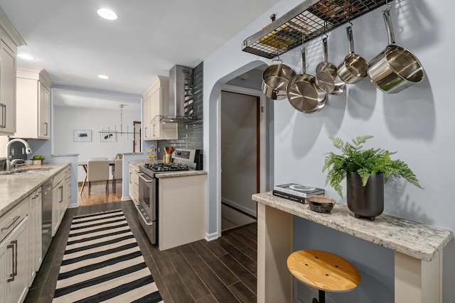 3287 Leighton Rd, Columbus, OH 43221 - kitchen with wall chimney exhaust hood, appliances with stainless steel finishes, white cabinetry, dark wood-style floors, and recessed lighting