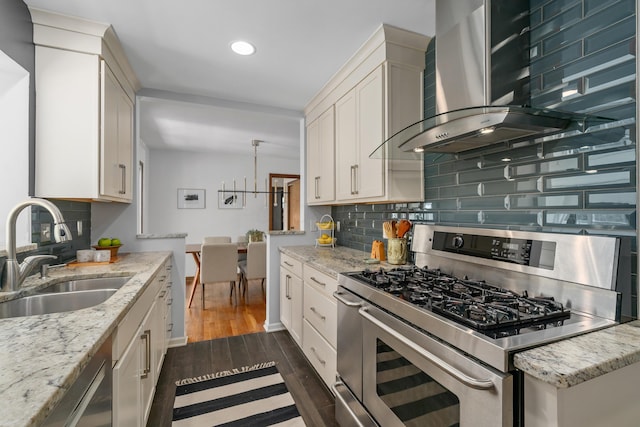 3287 Leighton Rd, Columbus, OH 43221 - kitchen featuring range with two ovens, wall chimney exhaust hood, decorative backsplash, recessed lighting, and white cabinetry