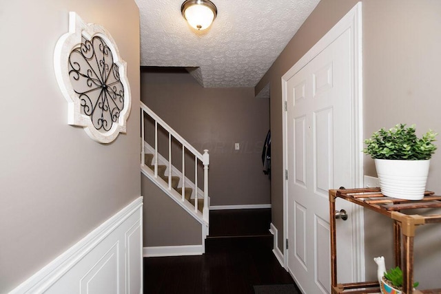 3790 Hunting Ln, Columbus, OH 43230 - stairs with wood finished floors and a textured ceiling