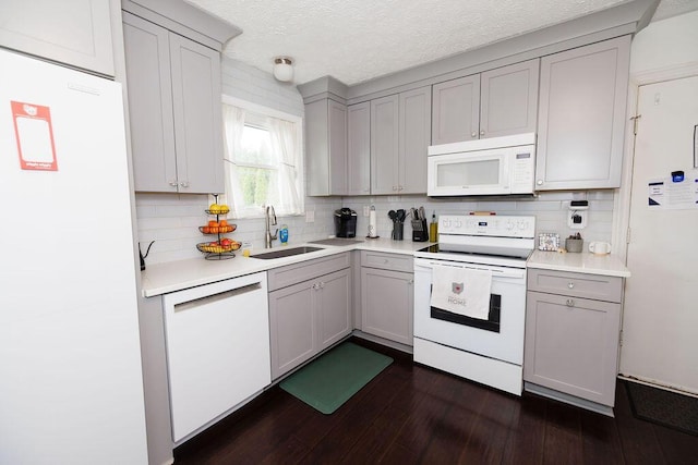 3790 Hunting Ln, Columbus, OH 43230 - kitchen featuring white appliances, gray cabinets, tasteful backsplash, dark wood-style floors, and light countertops