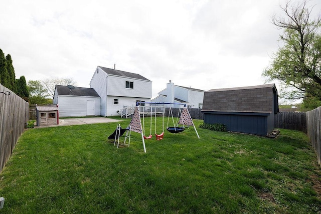 3790 Hunting Ln, Columbus, OH 43230 - fenced backyard featuring a playground, a storage shed, and a patio