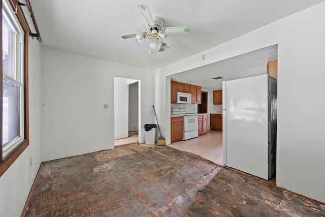 1716 Homer Rd NW, Utica, OH 43080 - kitchen featuring white appliances, brown cabinetry, plenty of natural light, and a ceiling fan