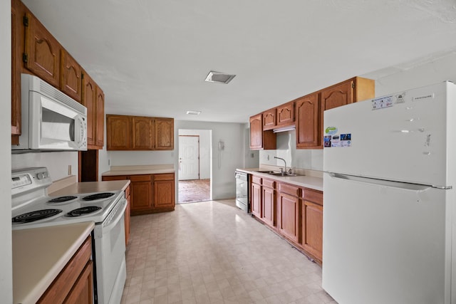 1716 Homer Rd NW, Utica, OH 43080 - kitchen with white appliances, light floors, light countertops, and brown cabinets
