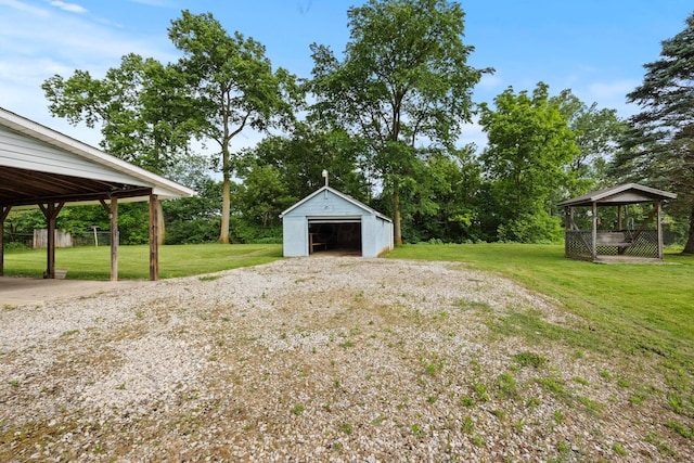 1716 Homer Rd NW, Utica, OH 43080 - view of green lawn featuring a detached garage and an outbuilding
