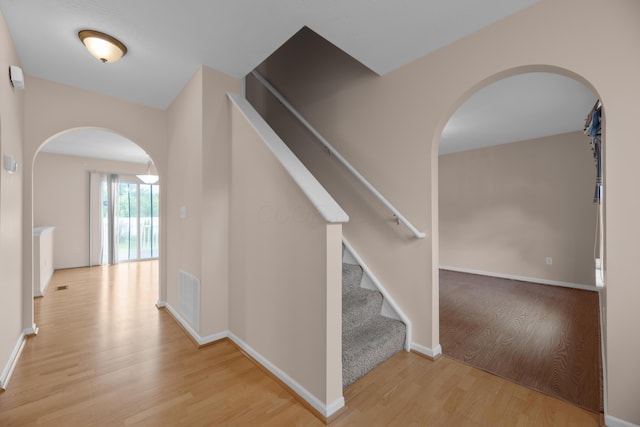 8101 Orange Station Loop, Lewis Center, OH 43035 - hallway with arched walkways, wood finished floors, and stairs