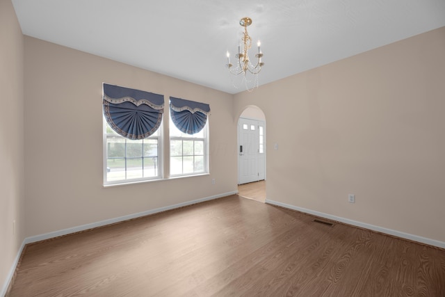 8101 Orange Station Loop, Lewis Center, OH 43035 - spare room with wood finished floors, arched walkways, and a chandelier