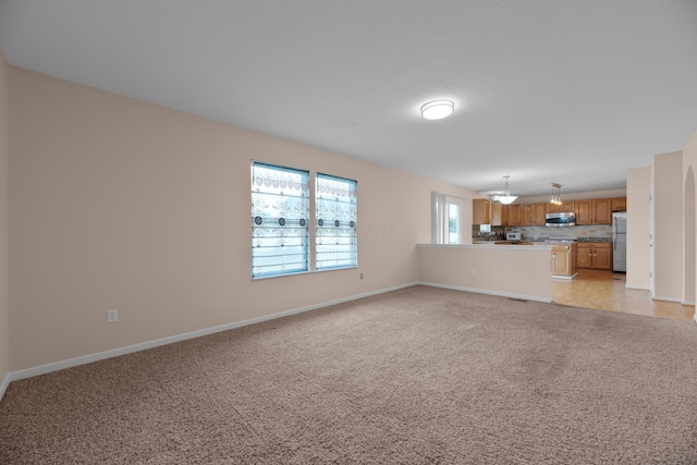 8101 Orange Station Loop, Lewis Center, OH 43035 - unfurnished living room featuring light carpet and baseboards