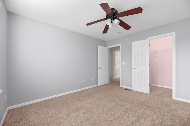 8101 Orange Station Loop, Lewis Center, OH 43035 - unfurnished bedroom featuring carpet, a walk in closet, a ceiling fan, and a closet