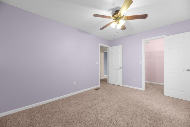 8101 Orange Station Loop, Lewis Center, OH 43035 - unfurnished bedroom featuring carpet, a walk in closet, a closet, and a ceiling fan