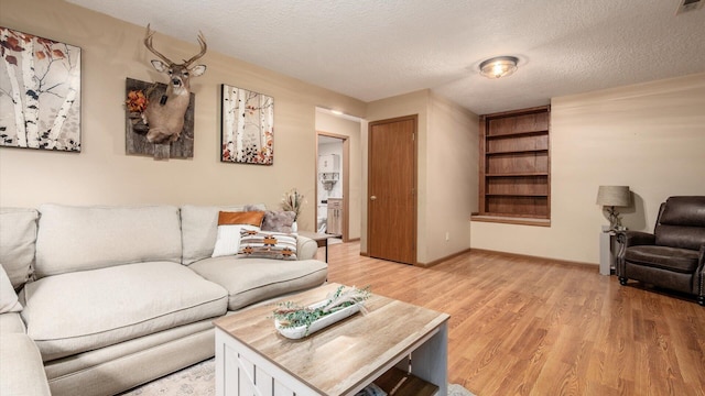 637 Livingston Ct, Heath, OH 43056 - living area with light wood finished floors and a textured ceiling