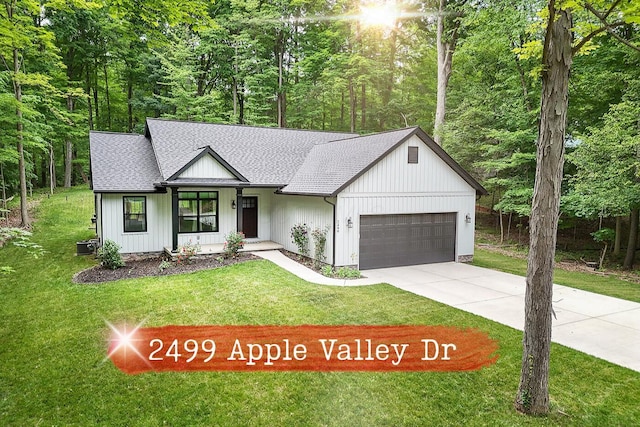 2499 Apple Valley Dr, Howard, OH 43028 - modern farmhouse featuring a shingled roof, a garage, a front lawn, and driveway