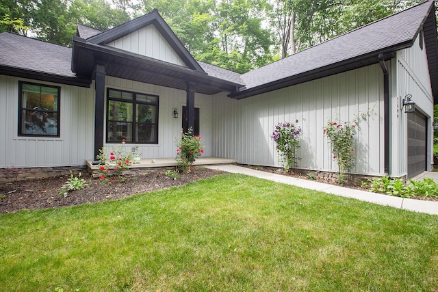 2499 Apple Valley Dr, Howard, OH 43028 - view of front of property featuring roof with shingles, a porch, a front lawn, and a garage