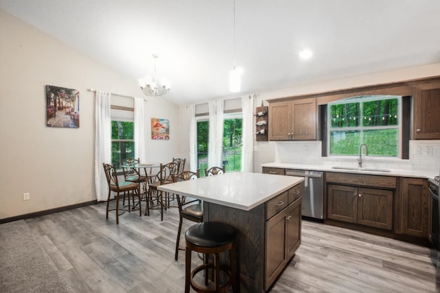 2499 Apple Valley Dr, Howard, OH 43028 - kitchen with dishwasher, backsplash, light countertops, a kitchen breakfast bar, and vaulted ceiling