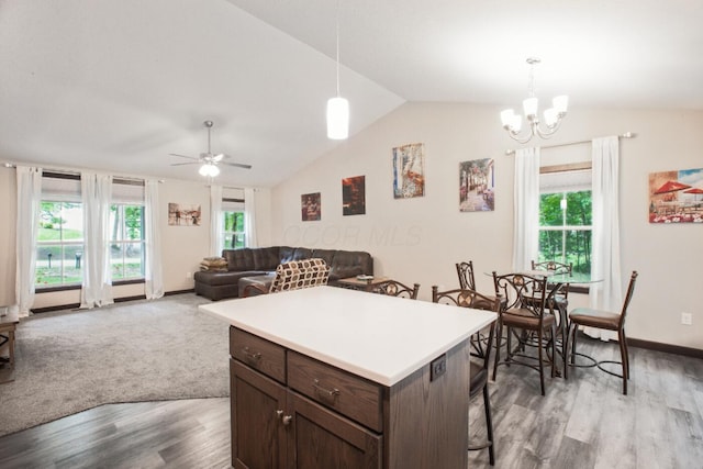 2499 Apple Valley Dr, Howard, OH 43028 - kitchen featuring wood finished floors, lofted ceiling, a breakfast bar area, dark brown cabinets, and ceiling fan