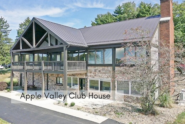 2499 Apple Valley Dr, Howard, OH 43028 - view of front of home with a standing seam roof, stone siding, a chimney, and a metal roof