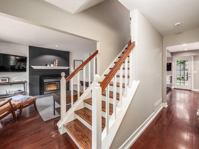 1243 Harrison Ave, Columbus, OH 43201 - staircase with a glass covered fireplace and hardwood / wood-style floors