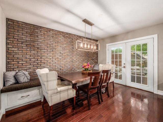 1243 Harrison Ave, Columbus, OH 43201 - dining space featuring brick wall, french doors, and wood finished floors